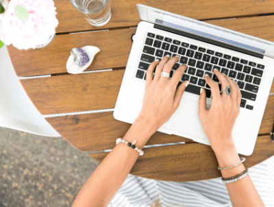 woman with jewellery using laptop